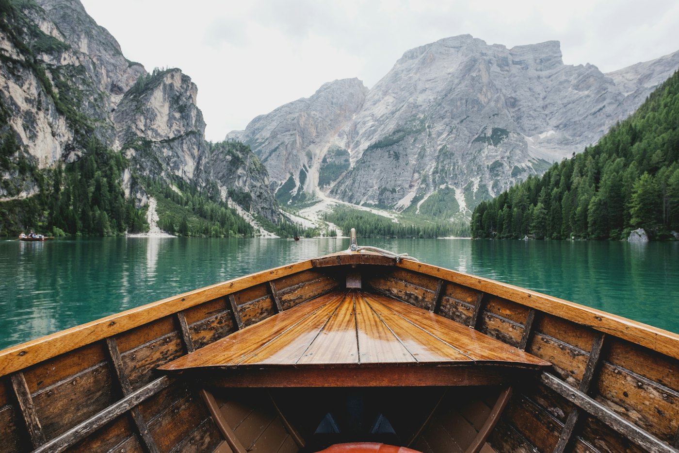 Un bote de madera en un lago, entre montañas